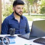 Young caucasian having meeting online at daytime outdoors.